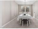 Dining room with white table and chairs, and a chandelier at 14271 W Alameda Rd, Surprise, AZ 85387