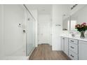 Spa-like bathroom with walk-in shower, double vanity, and gray cabinets at 17849 W Thistle Landing Dr, Goodyear, AZ 85338