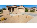Single story home with a two car garage and front walkway at 18076 W Nighthawk Way, Goodyear, AZ 85338