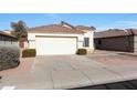 House exterior with a two-car garage and desert landscaping at 2042 E Aire Libre Ave, Phoenix, AZ 85022