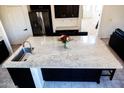Spacious kitchen island with granite countertops and stainless steel sink at 25696 W Williams Ct, Buckeye, AZ 85326