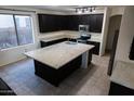 Spacious kitchen with island, granite countertops, and dark cabinetry at 25696 W Williams Ct, Buckeye, AZ 85326