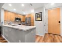 Modern kitchen with light wood cabinets and stainless steel appliances at 16 W Encanto Blvd # 609, Phoenix, AZ 85003