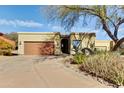 Single-story home with a two-car garage and mature trees at 18626 E Amarado Cir, Rio Verde, AZ 85263