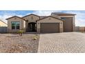 Two-story home with a three-car garage and paver driveway at 29507 N 224Th Dr, Wittmann, AZ 85361