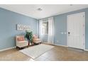 Living room with two armchairs, a plant, and a door leading outside at 4642 W Alabama Ln, San Tan Valley, AZ 85144
