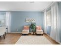 Light and airy living room with two armchairs and a decorative rug at 4642 W Alabama Ln, San Tan Valley, AZ 85144