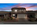 Two-story house with a beige exterior, two-car garage, and landscaping at 480 W Cucumber Tree Ave, Queen Creek, AZ 85140