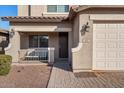Front entryway with a dark brown door and a small covered porch at 480 W Cucumber Tree Ave, Queen Creek, AZ 85140