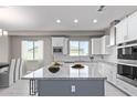 Modern kitchen with white cabinets, granite countertops, and stainless steel appliances at 1 N Brenner Pass Rd, Queen Creek, AZ 85144