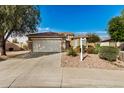 Two-story house with a two-car garage and well-maintained landscaping at 13348 W Calavar Cir, Surprise, AZ 85379