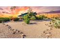House nestled in the desert landscape with a unique architectural style at 16409 E Kingstree Blvd, Fountain Hills, AZ 85268
