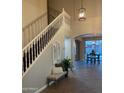 Bright entryway featuring high ceilings, staircase with white railing, and tile flooring at 1923 E Zion Way, Chandler, AZ 85249