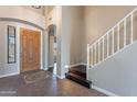 Elegant entryway with wood floors, a staircase, and a decorative tile inlay at 1923 E Zion Way, Chandler, AZ 85249
