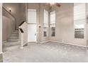 Spacious living room with high ceilings and a staircase at 30417 N 42Nd Pl, Cave Creek, AZ 85331