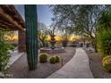 Stone pathway leads to fountain and sunset view at 35931 N 82Nd Pl, Scottsdale, AZ 85266