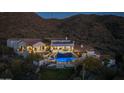 Luxury home with pool and mountain views at night at 4362 N Diamond Point Cir, Mesa, AZ 85207