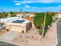 Aerial view of single-story house with solar panels, a saguaro cactus, and desert landscaping at 6164 E Minton Pl, Mesa, AZ 85215