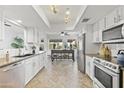 Bright kitchen with white cabinets, granite counters, and stainless steel appliances at 6164 E Minton Pl, Mesa, AZ 85215