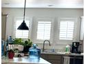 Bright kitchen with white shuttered windows and stainless steel faucet at 701 S Dobson Rd # 158, Mesa, AZ 85202