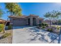 Single story home with stone accents and landscaped front yard at 19749 W Harrison St, Buckeye, AZ 85326