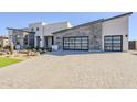 Modern home with a gray stone and white stucco exterior, and a paved driveway at 28409 N 59Th Way, Cave Creek, AZ 85331