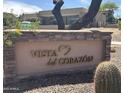 Stone community sign reading 'Vista del Corazon' set against a backdrop of desert landscaping and modern architecture at 3703 S Avenida De Angeles --, Gold Canyon, AZ 85118
