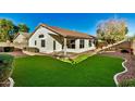 Spacious backyard with artificial turf and a covered patio at 9829 E Onza Ave, Mesa, AZ 85212