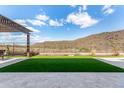 Artificial turf backyard with pergola and mountain views at 11578 W Montansoro Ln, Peoria, AZ 85383
