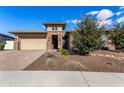 Beautiful desert landscaping surrounds this home with a large driveway at 11578 W Montansoro Ln, Peoria, AZ 85383