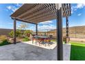 Pergola covered patio with seating for dining and entertaining at 11578 W Montansoro Ln, Peoria, AZ 85383