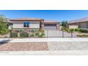 Single story home with a two-car garage, and well-manicured lawn at 1180 E Ridgerock St, Casa Grande, AZ 85122