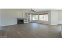 Living room with fireplace, built-in shelving, and hardwood floors at 1400 E Orchid Ln, Gilbert, AZ 85296