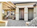 Inviting front entry with a pergola and a wooden door at 17103 S 182Nd Ln, Goodyear, AZ 85338