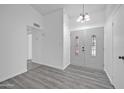 Entryway with double doors and grey laminate flooring at 6934 W Orange Dr, Glendale, AZ 85303