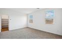 Bright bedroom with neutral carpeting and large windows at 9868 S Caballo Dr, Apache Junction, AZ 85120