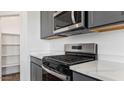 Stainless steel appliances and white countertops in a modern kitchen at 9913 S Los Picos Dr, Apache Junction, AZ 85120