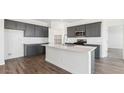 Modern kitchen featuring gray cabinetry, white countertops, and an island at 9913 S Los Picos Dr, Apache Junction, AZ 85120