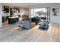 Open concept living space with modern furniture and access to a patio at 103 E Quartz Rock Rd, Phoenix, AZ 85085