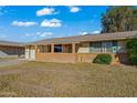 Brick house with a covered porch and mature landscaping at 10632 W Roundelay Cir, Sun City, AZ 85351