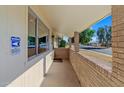 Covered porch with brick columns and tile flooring at 10632 W Roundelay Cir, Sun City, AZ 85351