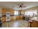 Bright kitchen features wood cabinets, modern appliances, and tile floors at 11865 N Allegro Rd, Maricopa, AZ 85139