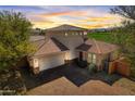 Beautiful two-story home with tile roof, red door and a courtyard at 13578 W Cypress St, Goodyear, AZ 85395