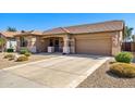 One-story house with desert landscaping, two-car garage, and neutral color scheme at 17937 W Udall Dr, Surprise, AZ 85374