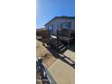 Front view of a manufactured home with a wooden deck and stairs at 18002 N 20Th N Pl, Phoenix, AZ 85022