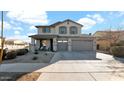 Two-story house with gray siding, a three-car garage, and a landscaped front yard at 18225 W Foothill Dr, Surprise, AZ 85387