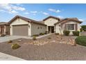 Charming one-story house with a two-car garage and nicely landscaped front yard at 26180 W Firehawk Dr, Buckeye, AZ 85396