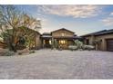 Single-story home with desert landscaping and a large driveway at 38450 N 95Th Way, Scottsdale, AZ 85262