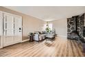 Living room featuring a stone fireplace and wood-look floors at 4950 N Miller Rd # 210, Scottsdale, AZ 85251