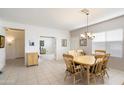 Dining area with a wooden table and chairs, offering views to another room at 9846 E Stone Circle Ln, Gold Canyon, AZ 85118